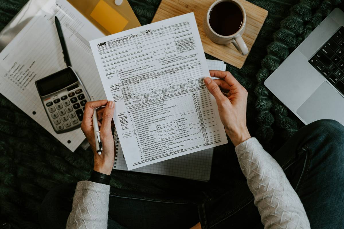 tax tutorial online showing student reviewing IRS forms on laptop with highlighted deductions